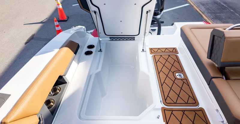 Slide: The Image of The image shows the interior of a 2026 Cobalt R6B boat with brown upholstery. - 10