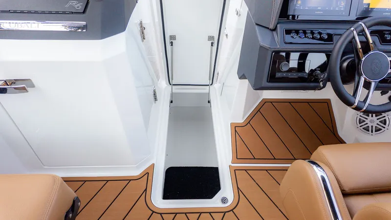 Slide: The Image of Interior of a Cobalt R6B boat with brown flooring and a steering console. - 17