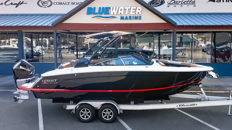 Slide: The Image of A 2026 Cobalt R6B boat on a trailer in front of a marine store. - 31