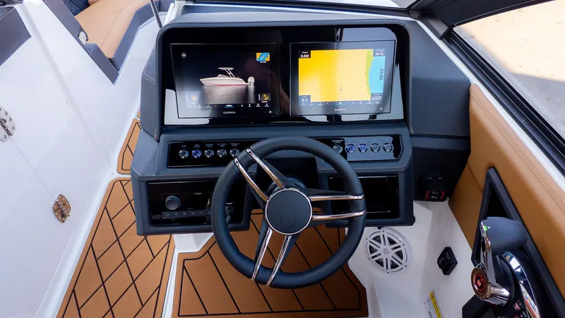 Slide: The Image of The image shows the cockpit of a Cobalt R6B boat with modern instruments and a sleek steering wheel. - 25