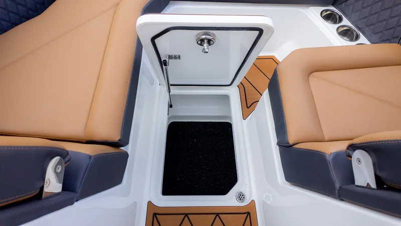 Slide: The Image of An open storage compartment between two cushioned seats on a boat. - 23