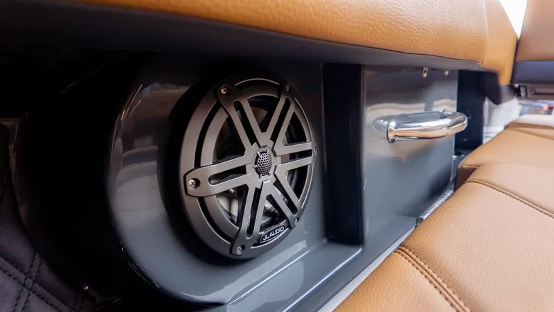 Slide: The Image of Close-up of a speaker and grab handle in a boat with brown upholstery. - 28