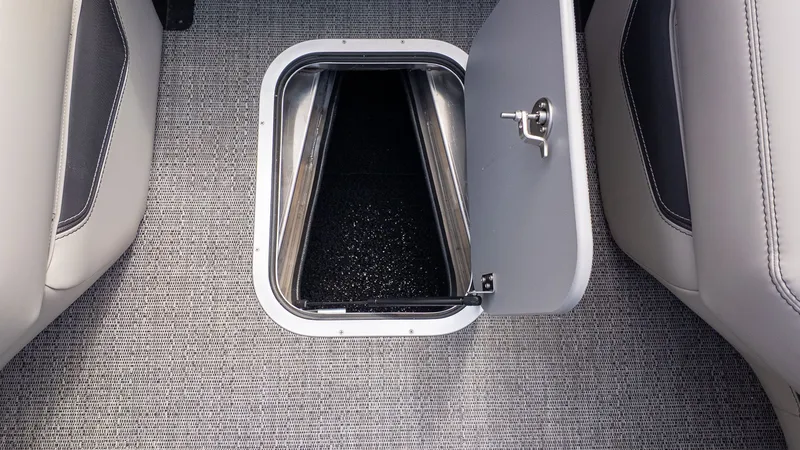 Slide: The Image of Open floor hatch on a boat with gray carpet flooring. - 21
