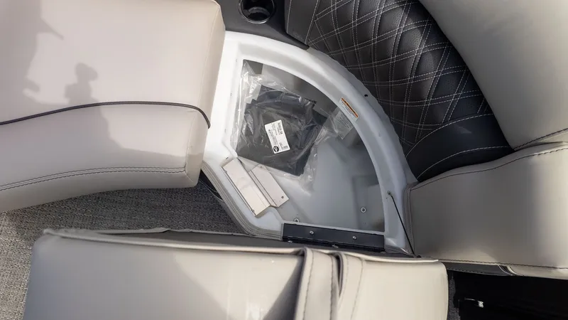 Slide: The Image of A seating area with gray upholstery and storage space underneath. - 20