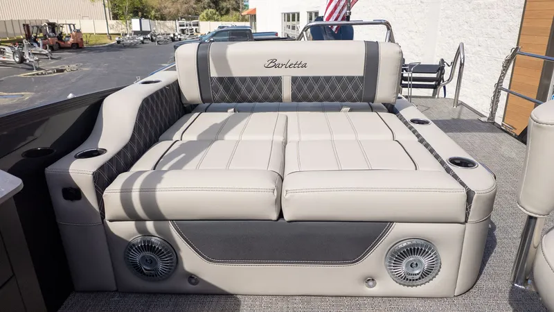 Slide: The Image of The image shows a luxurious seating area on a Barletta Lusso 25UE boat. - 33