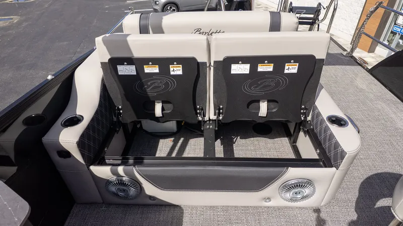 Slide: The Image of Rear view of two cushioned seats on a boat, featuring speakers and cup holders. - 32
