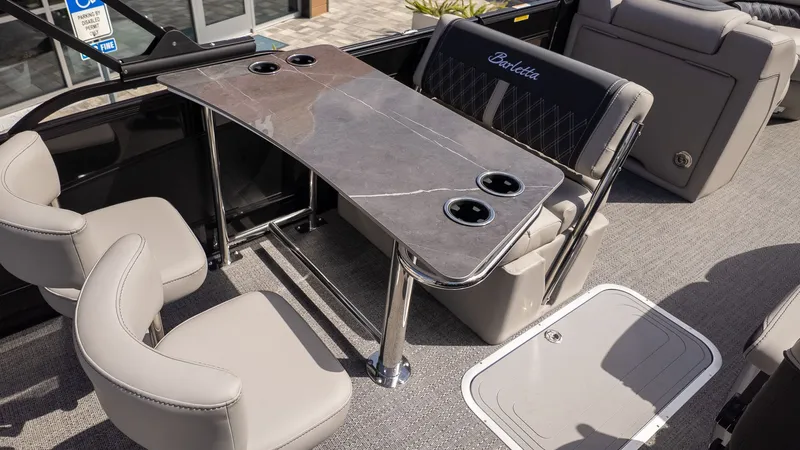 Slide: The Image of Barletta Lusso 25UE 2026: Elegant interior with gray table and comfortable seating. - 11