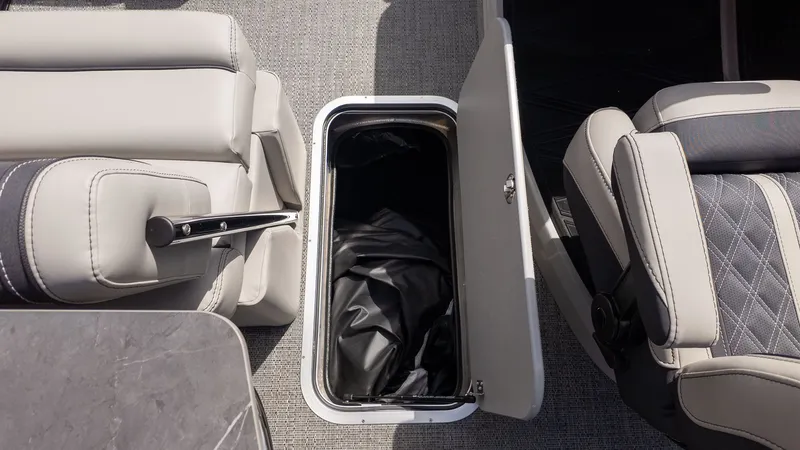 Slide: The Image of Interior of a Barletta Lusso 25UE with storage compartment and cushioned seats. - 28