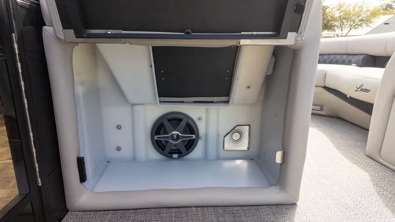 Slide: The Image of A speaker and vent grille inside a storage compartment on a boat. - 14