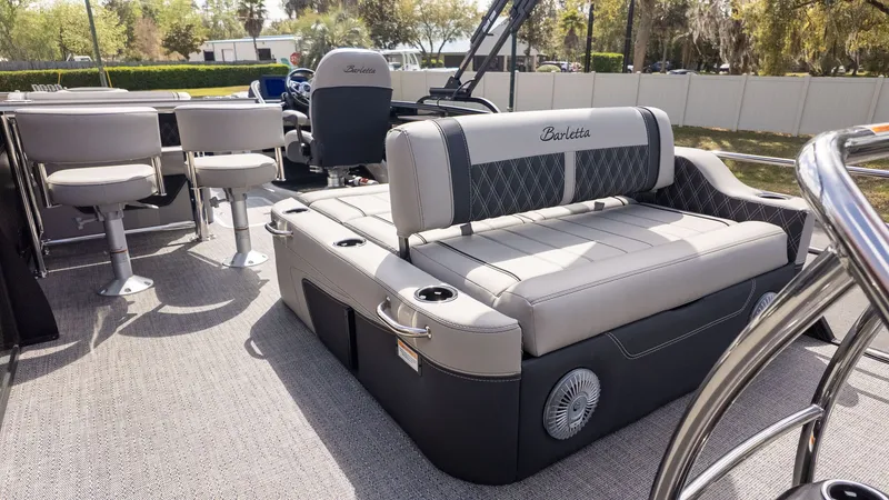 Slide: The Image of The image shows the interior of a Barletta Lusso 25UE boat with elegant seating and a table. - 33