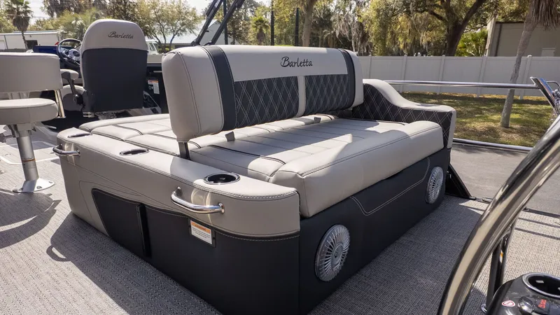 Slide: The Image of The image shows the luxurious seating of a Barletta Lusso 25UE boat with elegant details. - 7