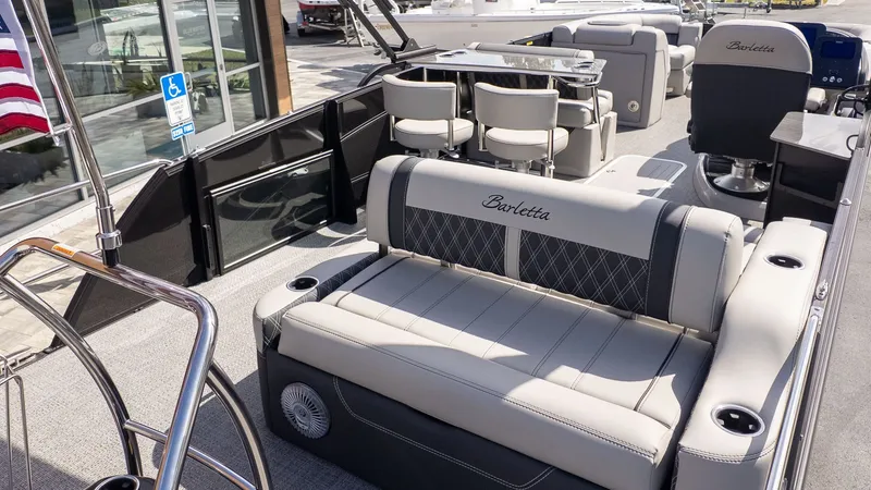 Slide: The Image of The image shows the interior of a Barletta Lusso 25UE boat with luxurious seating. - 6