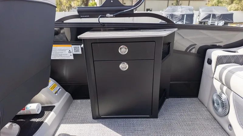 Slide: The Image of Interior of a Barletta Lusso 25UE featuring a black cabinet and gray carpet flooring. - 28