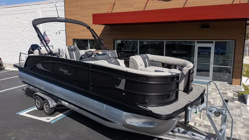 Slide: The Image of 2026 Barletta Lusso 25UE on a trailer parked in front of a building. - 4
