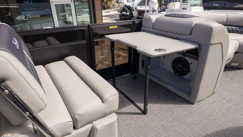 Slide: The Image of Interior of a Barletta Lusso 25UE with gray upholstery and a folding table. - 12