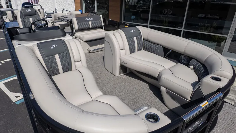 Slide: The Image of The image shows the interior of a Barletta Lusso 25UE pontoon boat with luxurious seating. - 4