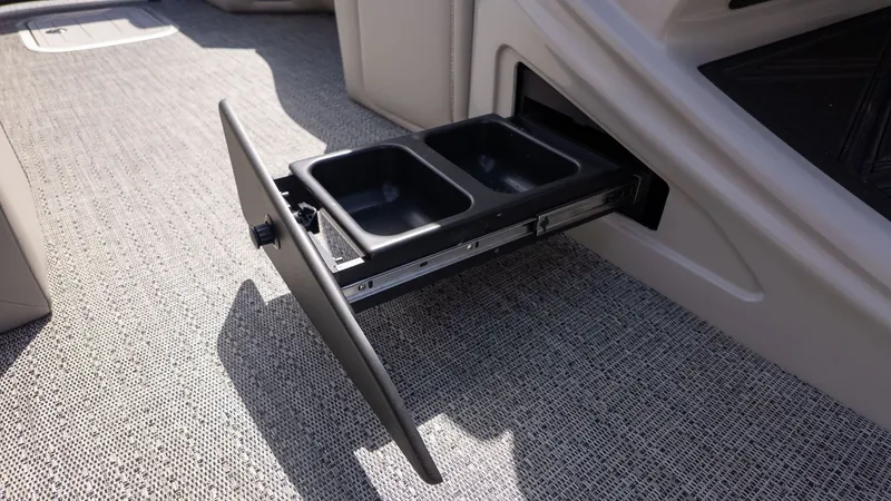 Slide: The Image of A pull-out compartment with two black bins on a boat. - 33