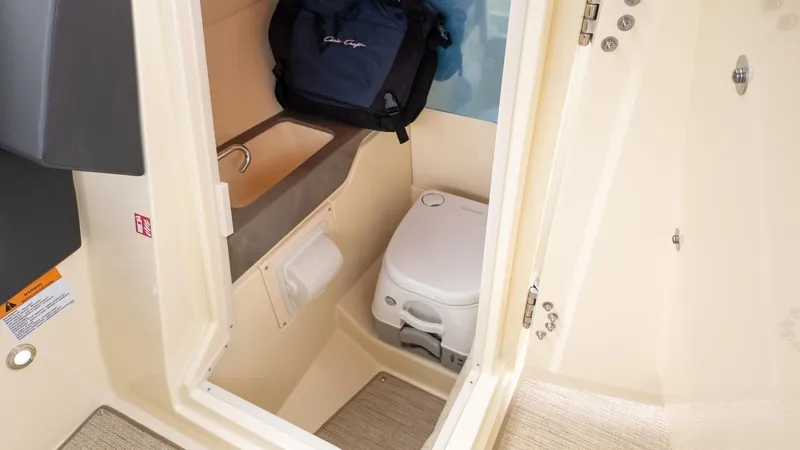 Slide: The Image of Interior of a boat cabin with a toilet and sink. - 27