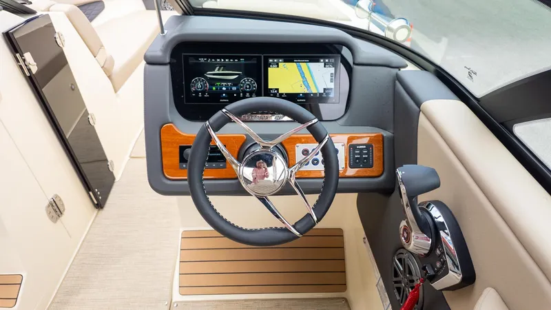Slide: The Image of The image shows the cockpit of a 2026 Chris-Craft Sportster 28 with modern instruments. - 22