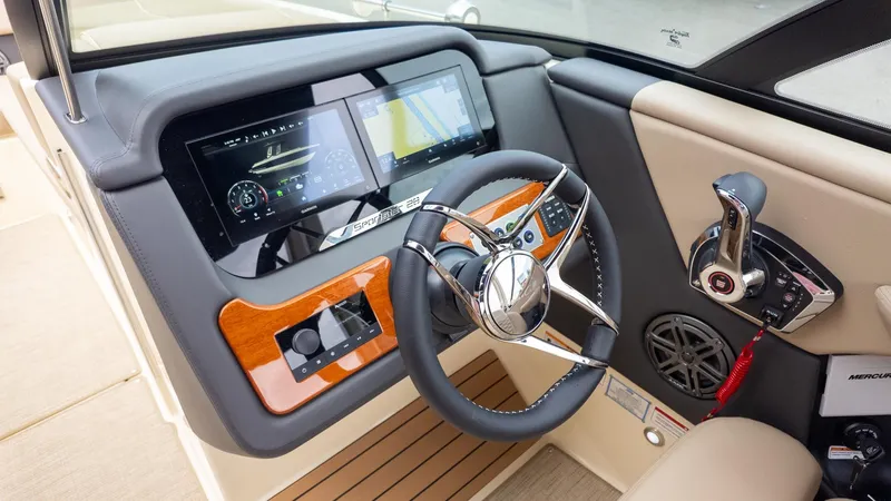 Slide: The Image of The image shows the cockpit of a 2026 Chris-Craft Sportster 28 with modern instruments. - 23