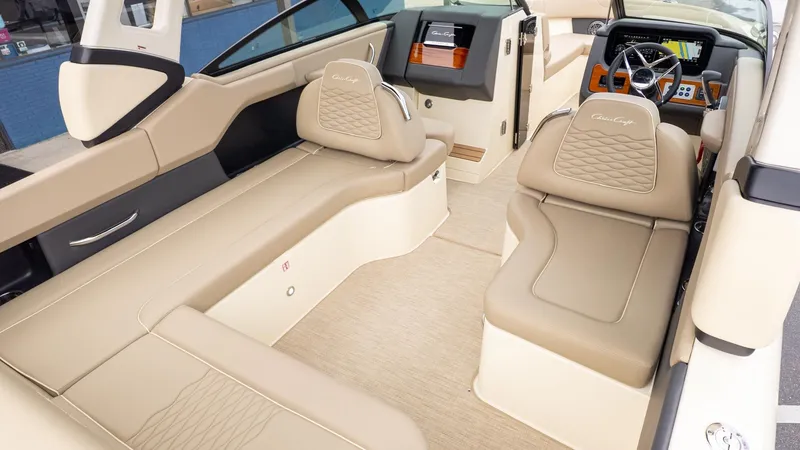 Slide: The Image of Interior of a Chris-Craft Sportster 28 with beige leather seating and a modern dashboard. - 7