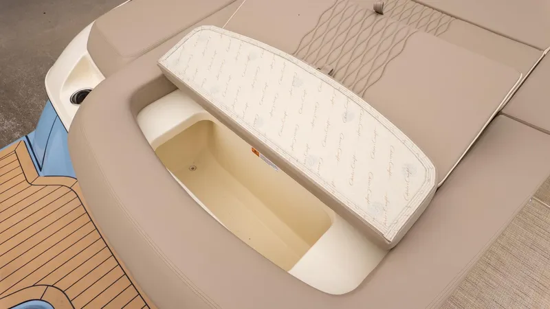 Slide: The Image of The image shows the beige upholstery and storage compartment of a 2026 Chris-Craft Sportster 28. - 5