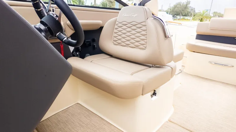 Slide: The Image of Interior view of a Chris-Craft Sportster 28 with beige leather seat and steering wheel. - 21