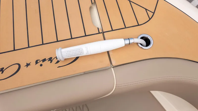 Slide: The Image of Close-up of a boat deck with a water hose connection and Chris-Craft logo. - 18