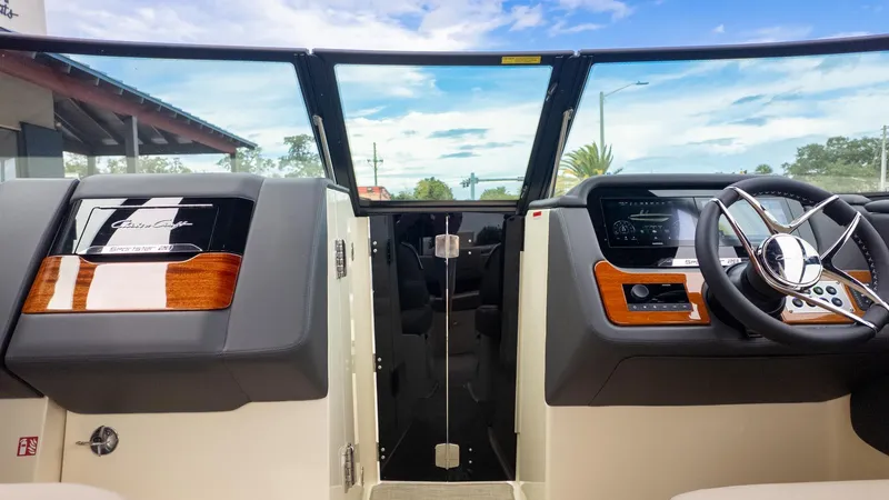 Slide: The Image of Interior view of a Chris-Craft Sportster 28 with modern dashboard and wood accents. - 16