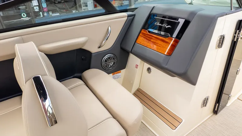 Slide: The Image of Interior of a Chris-Craft Sportster 28 with beige leather seats and sleek wood paneling. - 15
