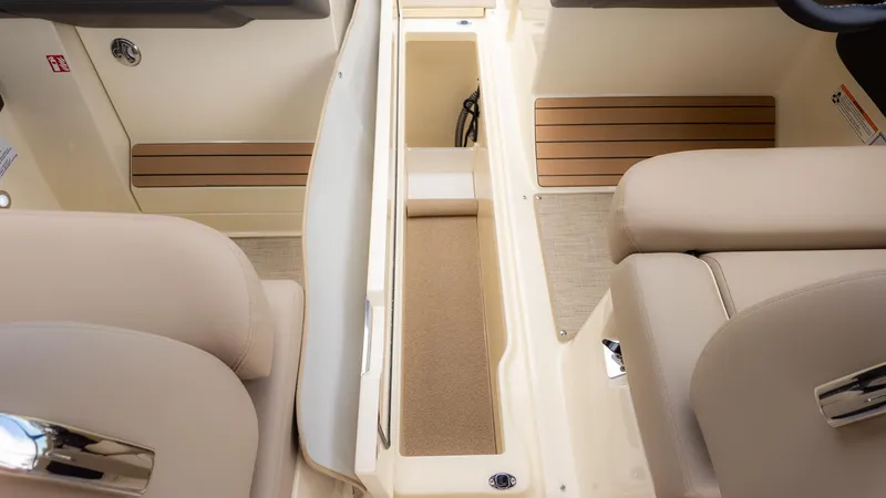 Slide: The Image of Interior of a Chris-Craft Sportster 28 with beige seats and wood flooring. - 10