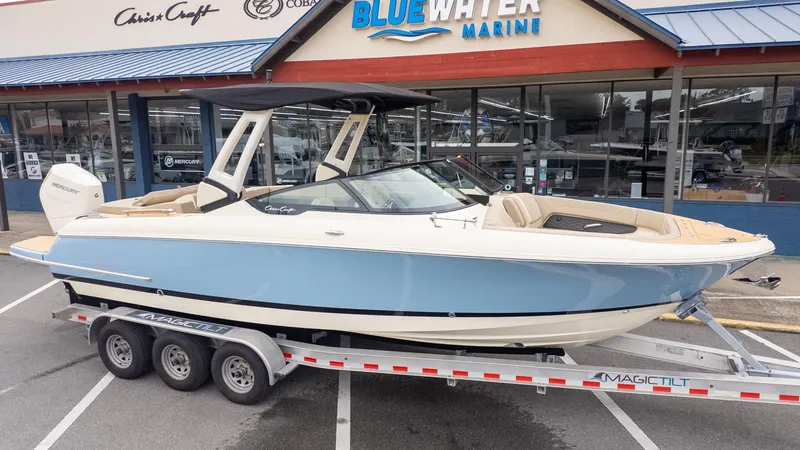 The Image of A 2026 Chris-Craft Sportster 28 on a trailer in front of a boat dealership. - 1