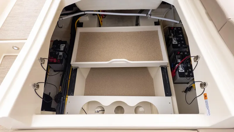 Slide: The Image of View of a Chris-Craft Sportster 28 engine compartment with batteries and storage space. - 5
