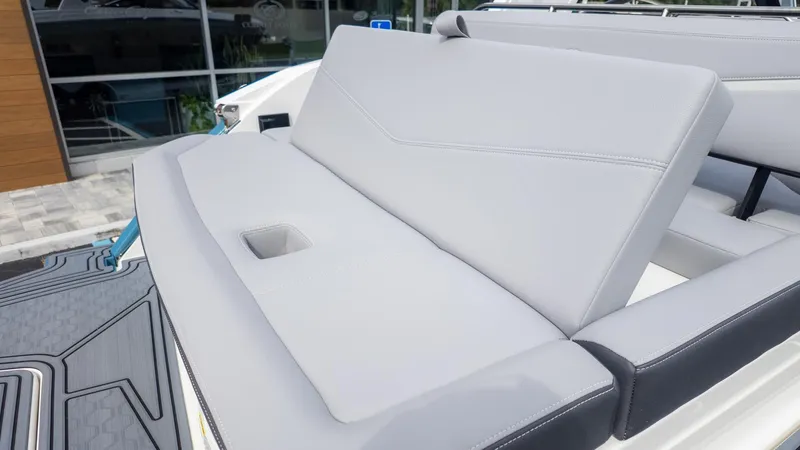 Slide: The Image of The image shows a gray bench seat on a boat, likely in the stern area. - 13