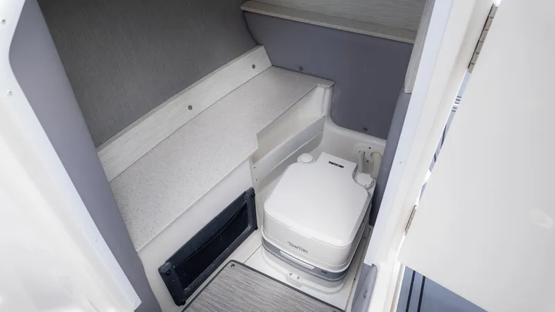 Slide: The Image of Interior of the 2026 Cobalt R6 Surf with a small toilet and seating area. - 19