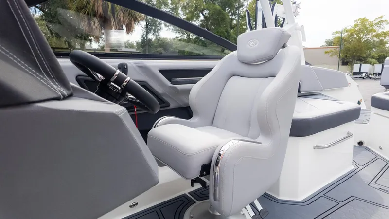 Slide: The Image of The interior of a 2026 Cobalt R6 Surf boat with a luxurious gray captain's chair. - 27