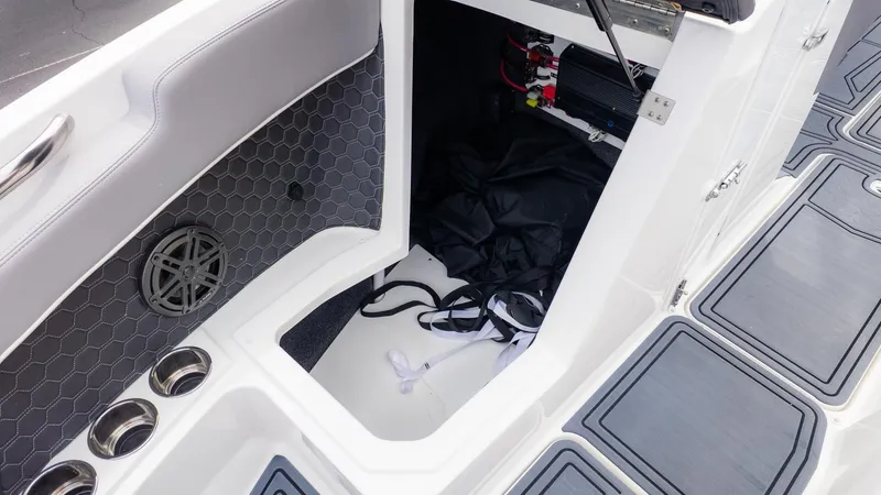 Slide: The Image of Interior of a Cobalt R6 Surf boat with storage compartment and gray upholstery. - 26