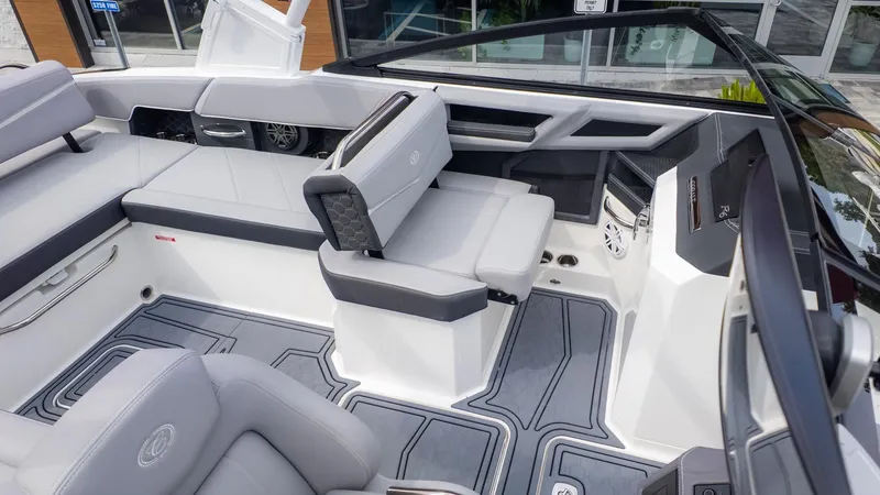 Slide: The Image of Interior of a modern boat with gray and white seating, sleek controls, and stylish design. - 9