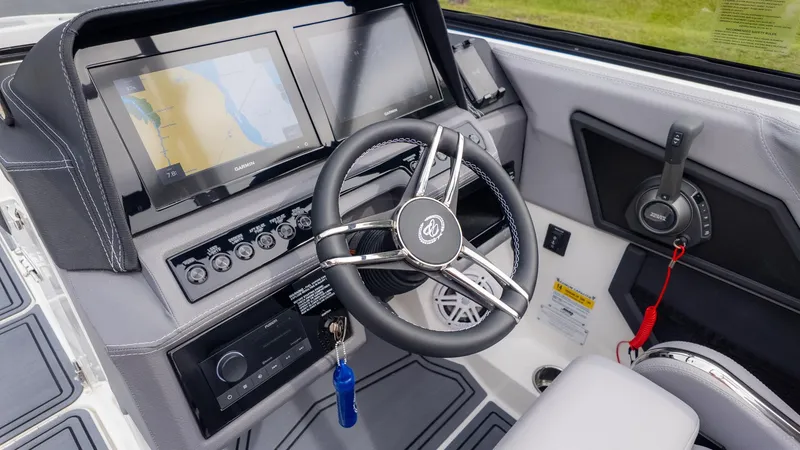 Slide: The Image of The image shows the cockpit of a Cobalt R6 Surf boat with modern instruments and a sleek steering wheel. - 28