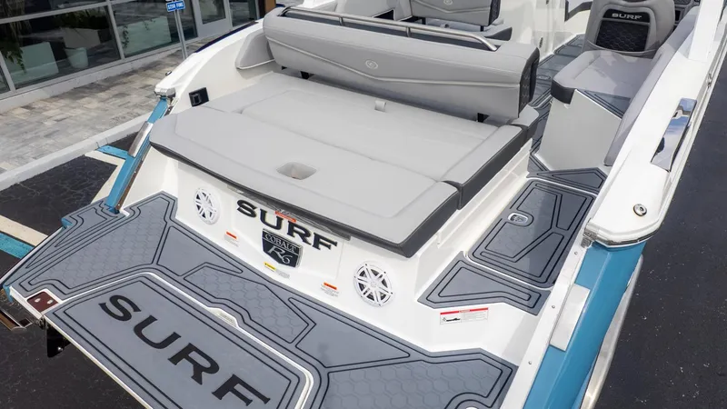 Slide: The Image of The image shows the stern of a Cobalt R6 Surf boat with gray upholstery and surf branding. - 6