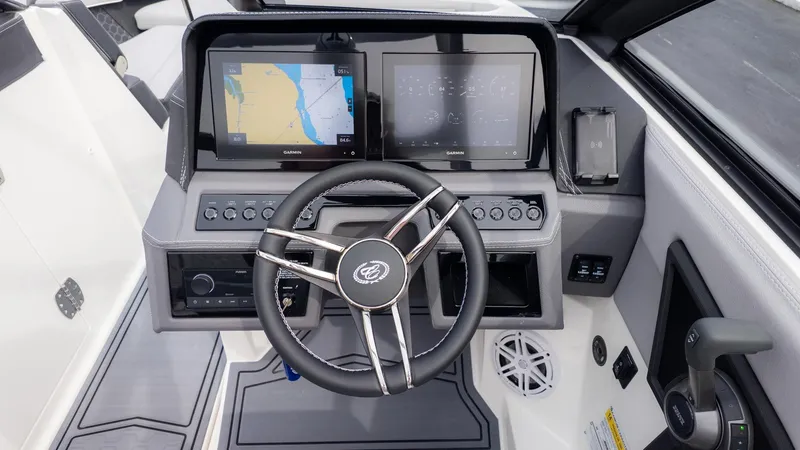 Slide: The Image of The image shows the cockpit of a Cobalt R6 Surf boat with modern navigation systems. - 27