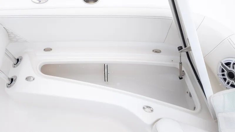 Slide: The Image of The image shows an open storage compartment on a boat with white upholstery and speakers. - 18