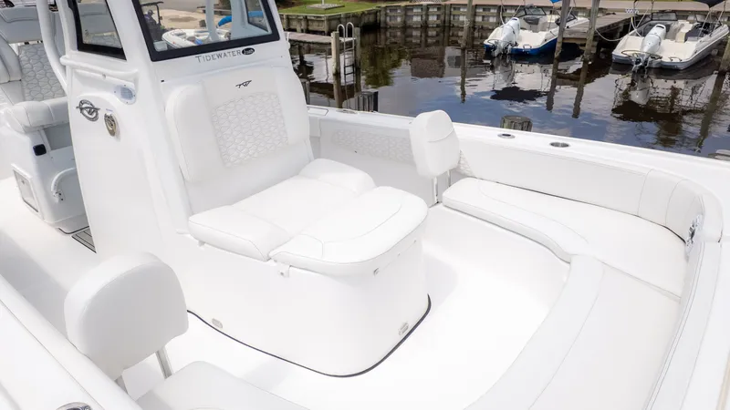 Slide: The Image of The image shows the cockpit of a Tidewater 2700 Carolina Bay boat at a marina. - 16