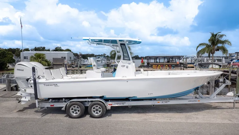 Slide: The Image of A Tidewater 2700 Carolina Bay boat on a trailer, featuring a blue T-top and twin outboard engines. - 24