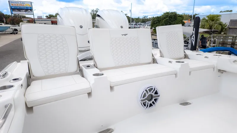 Slide: The Image of The 2026 Tidewater 2700 Carolina Bay features white cushioned seats and speakers in the rear area. - 5
