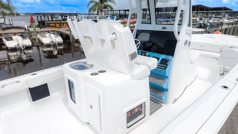 Slide: The Image of The image shows a modern boat with a white helm station and blue accents at a marina. - 8