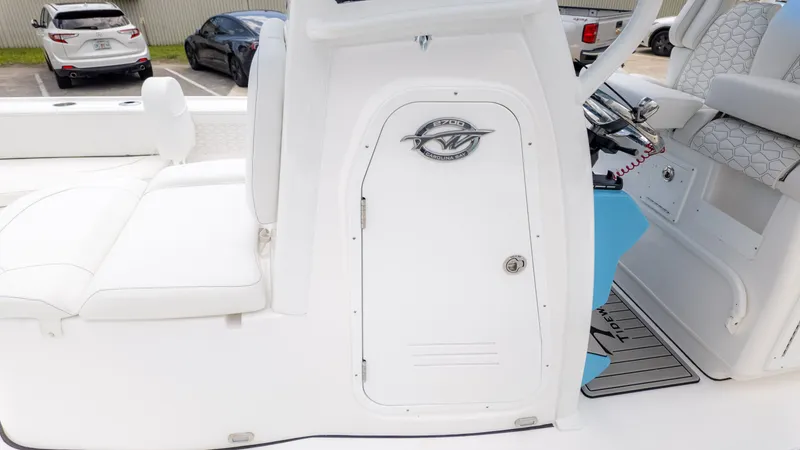 Slide: The Image of The image shows the cockpit of a Tidewater 2700 Carolina Bay boat with white upholstery. - 22