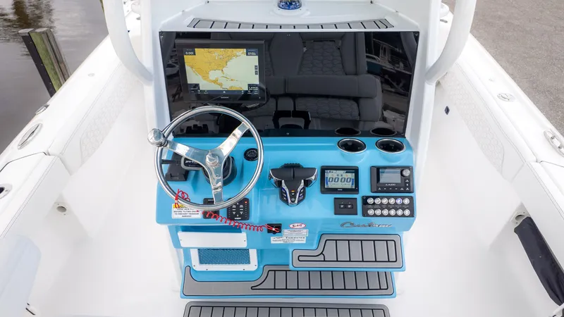 Slide: The Image of The image shows the helm of a Tidewater 2700 Carolina Bay boat with modern instruments. - 10