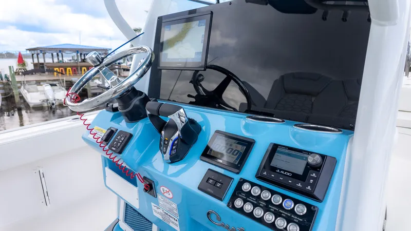 Slide: The Image of The image shows the helm of a Tidewater 2700 Carolina Bay boat with modern instruments. - 12