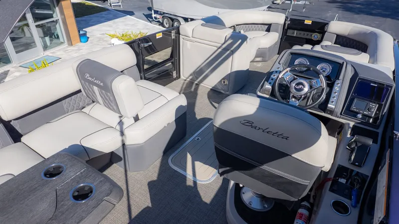 Slide: The Image of The image shows the interior of a 2024 Barletta Reserve Leggera 26MA with luxurious seating. - 13